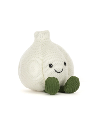 A knitted garlic plush toy in off-white with green feet and a simple embroidered smiley face, photographed on a clean white background.
