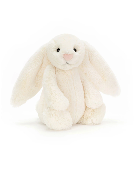 A plush cream-colored bunny toy with long floppy ears, small black eyes, and a pink nose, sitting on a clean white background.