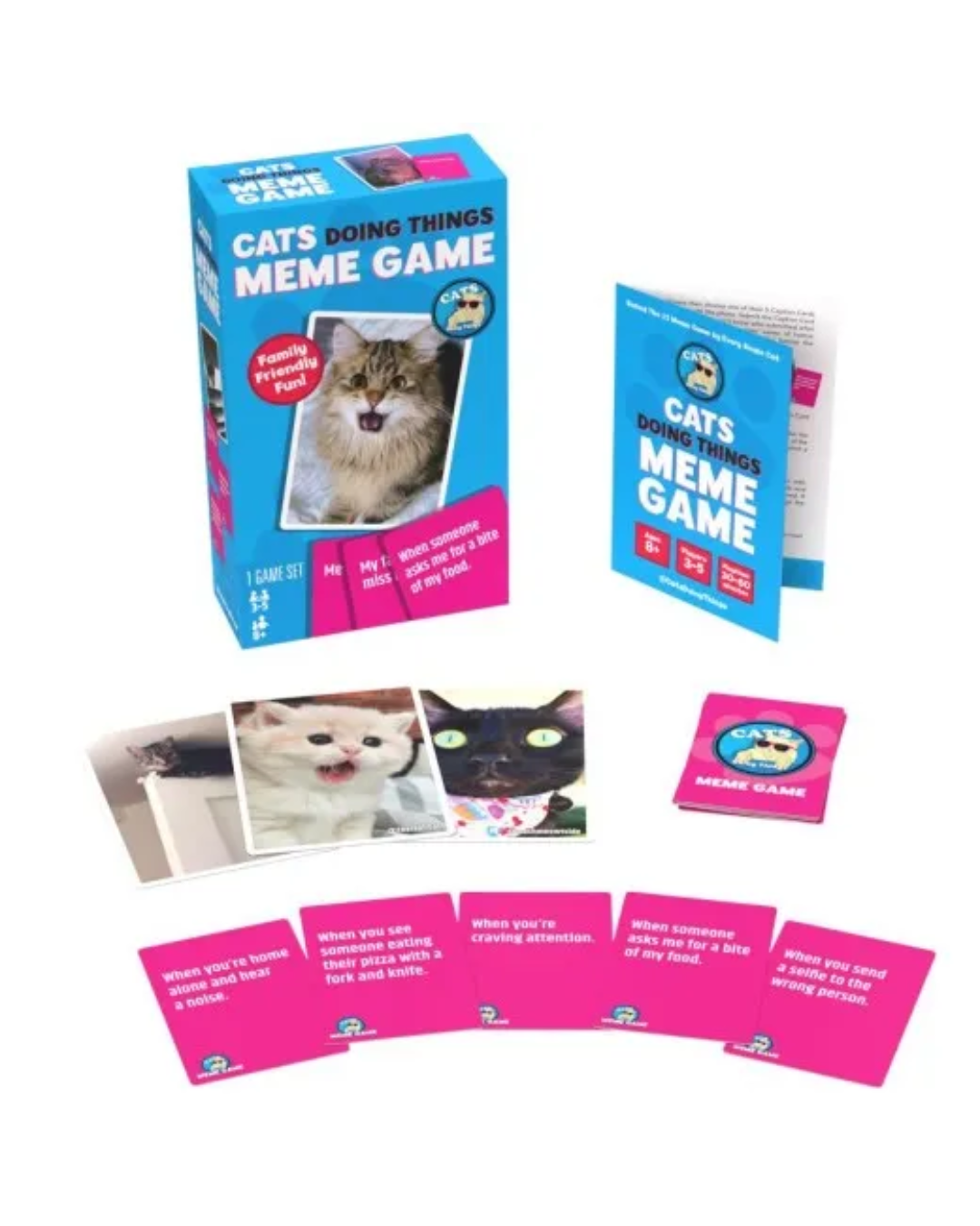 Cats Doing Things Meme Game set with a blue and pink box, instruction booklet, cards, and a small deck of cards on a white background.