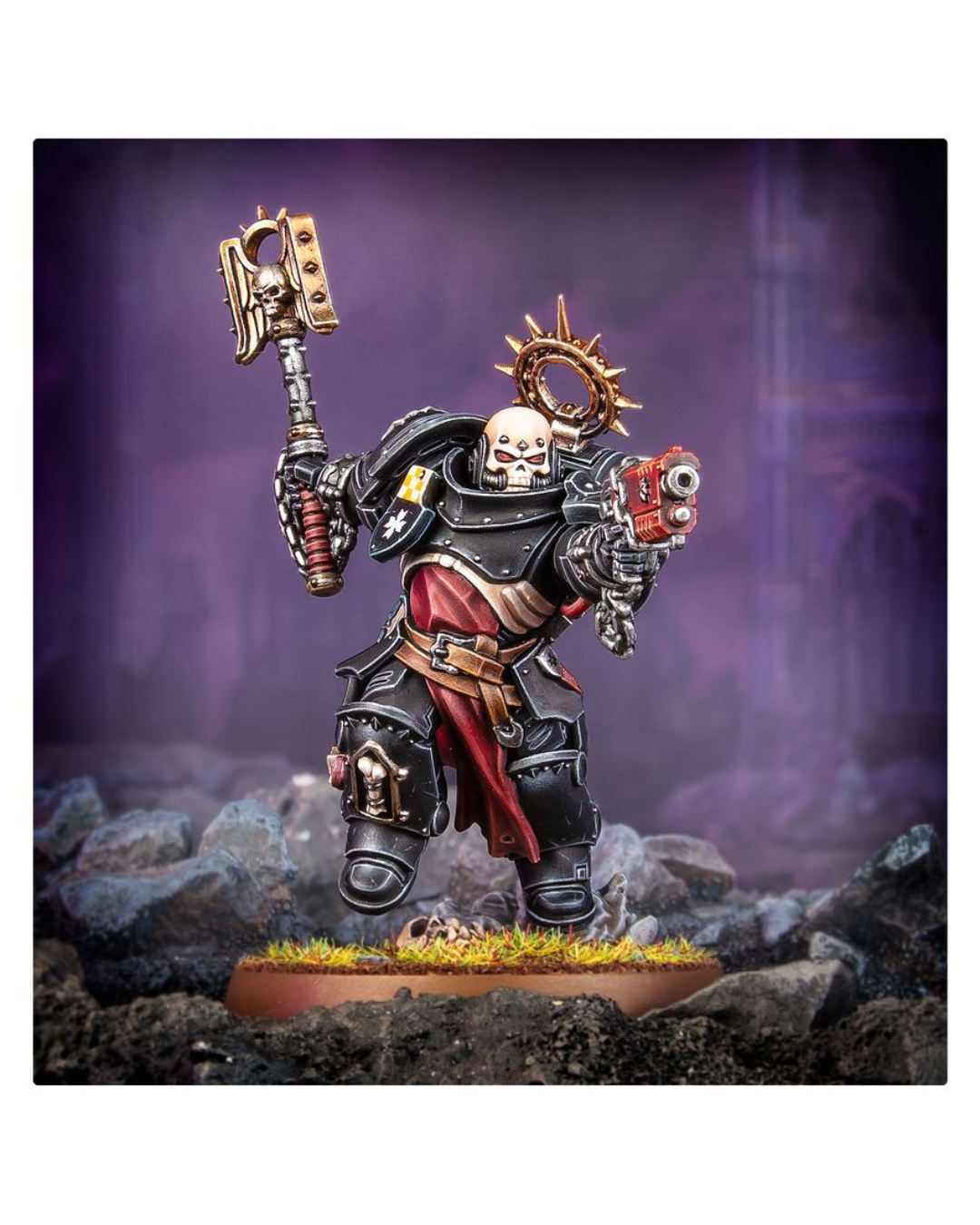 A painted miniature figurine of a skeletal warrior in black and red armor, holding a large hammer in one hand and a red weapon in the other, standing on a rocky base against a purple fantasy background.