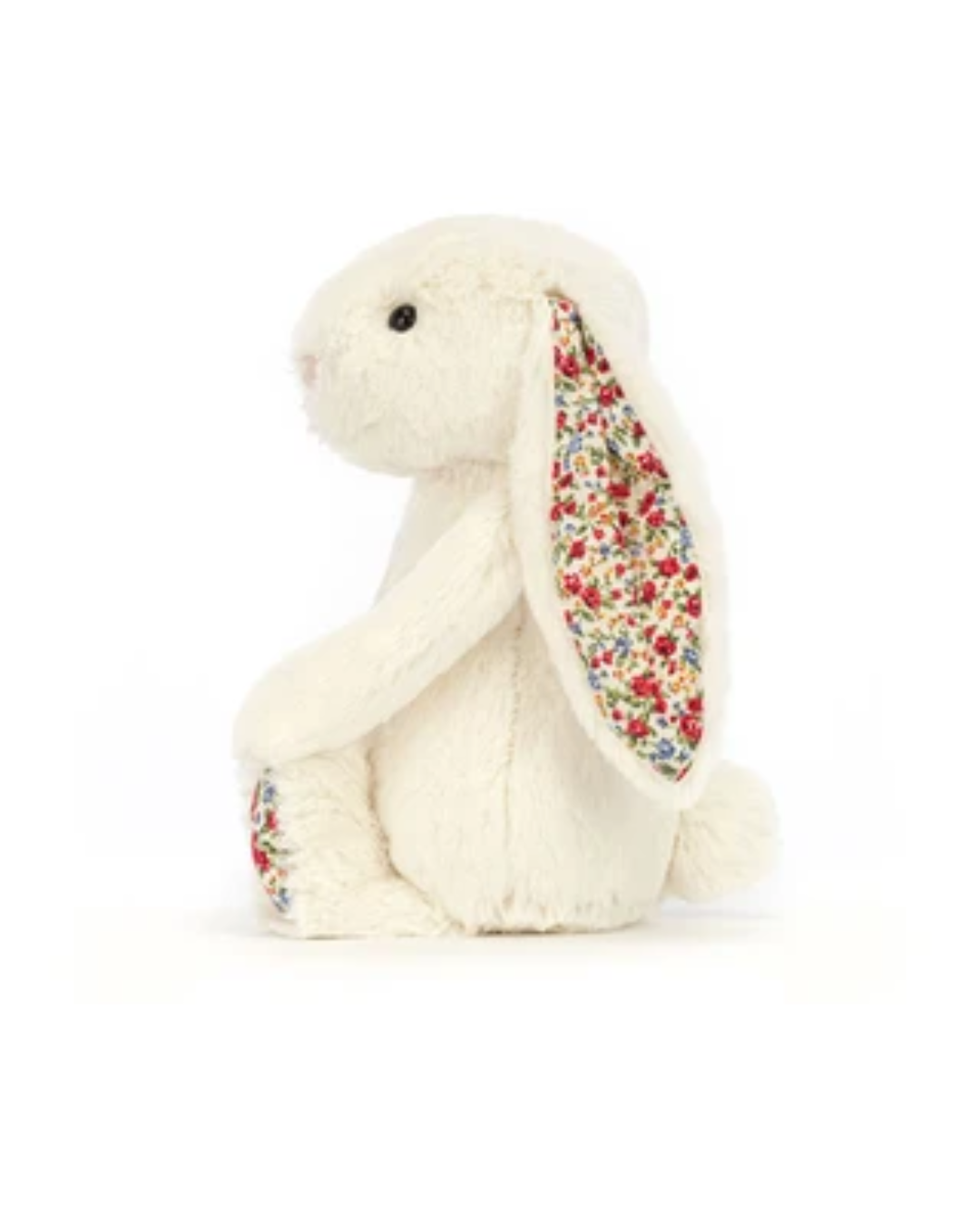 A cream-colored plush bunny toy with long floppy ears featuring a colorful floral pattern, sitting against a plain white background.