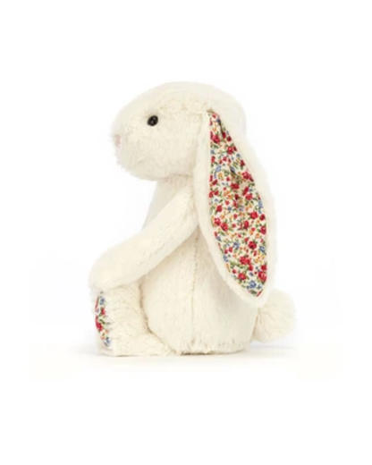 A cream-colored plush bunny toy with long floppy ears featuring a colorful floral pattern, sitting against a plain white background.