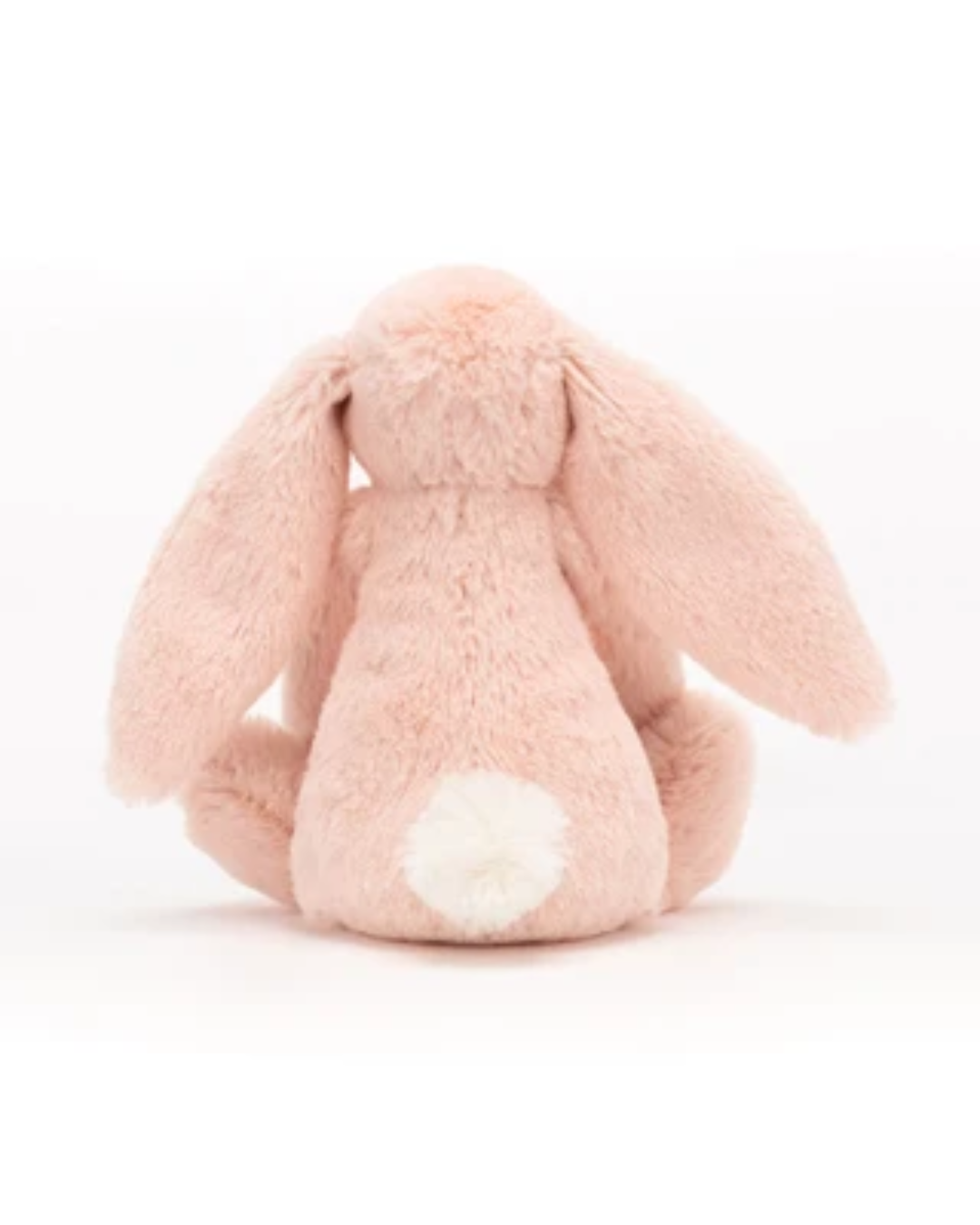 A light pink plush bunny toy shown from the back, featuring long floppy ears and a small white tuft on its tail, set against a plain white background.