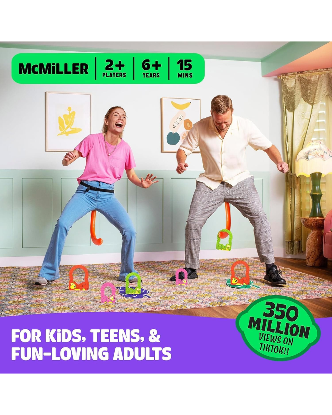 Two adults playing a colorful dance game in a decorated room, with hanging letters and legs on the floor. Prominent text overlays read 'McMILLER', '2+ PLAYERS', '6+ YEARS', '15 MINS', and 'FOR KIDS, TEENS, & FUN-LOVING ADULTS' with a green badge saying '350 MILLION VIEWS ON TIKTOK!!'.
