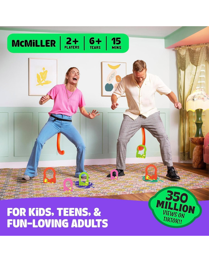 Two adults playing a colorful dance game in a decorated room, with hanging letters and legs on the floor. Prominent text overlays read 'McMILLER', '2+ PLAYERS', '6+ YEARS', '15 MINS', and 'FOR KIDS, TEENS, & FUN-LOVING ADULTS' with a green badge saying '350 MILLION VIEWS ON TIKTOK!!'.