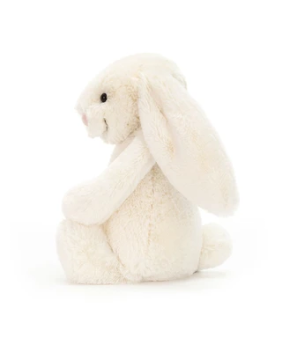 A cream-colored plush bunny toy with long floppy ears, sitting on a seamless white background.