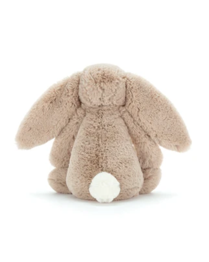 A plush bunny toy photographed from the back on a clean white background. The bunny is a warm light tan/beige color with a small white fluffy tail.