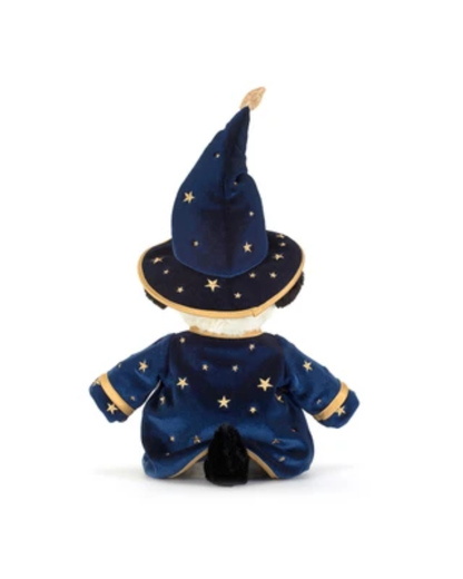 A plush wizard doll shown from the back, wearing a navy blue velvet robe and pointed hat decorated with gold stars and trim, set against a plain white background.