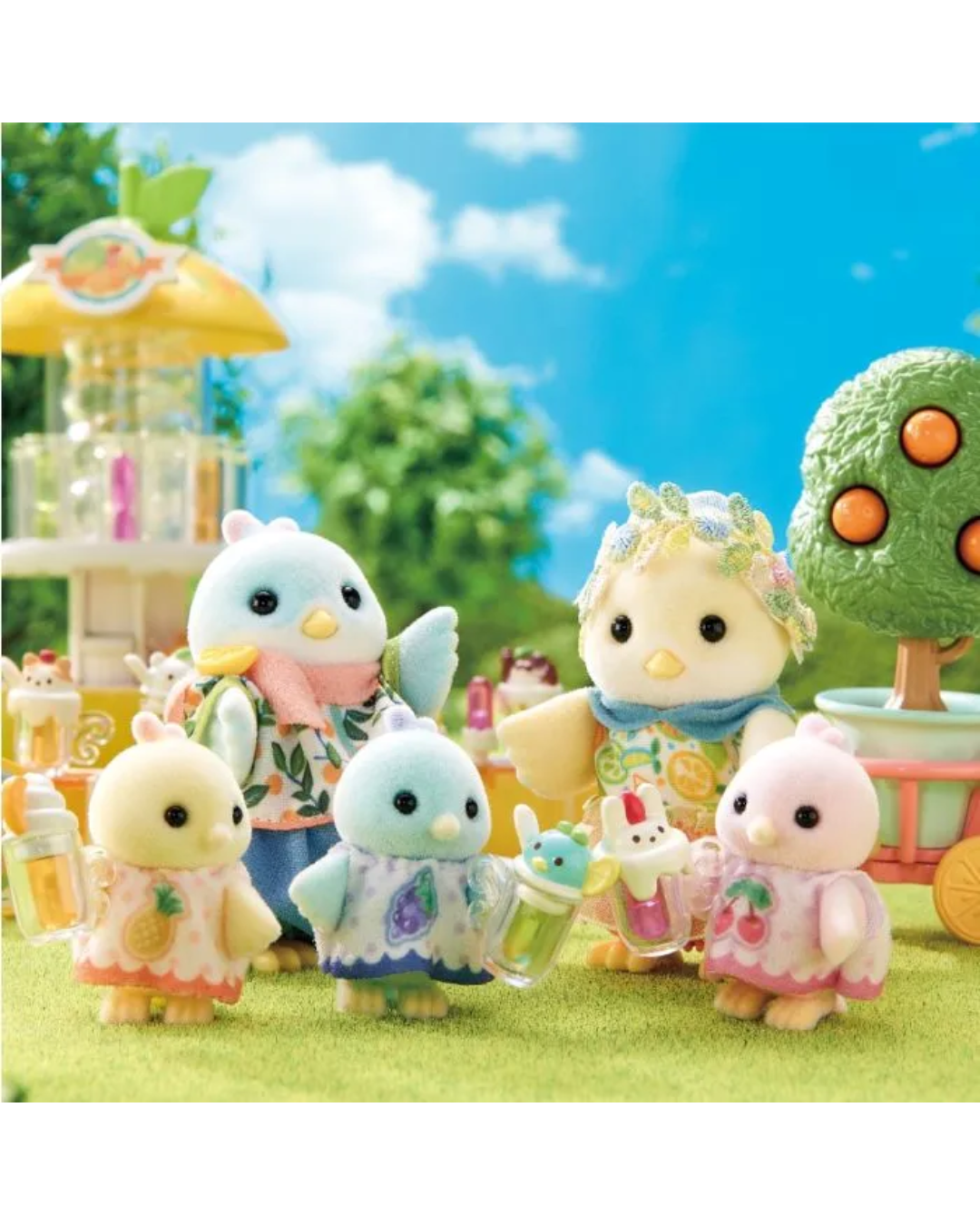 A Sylvanian bird family against a background with an orange tree and blurred background 