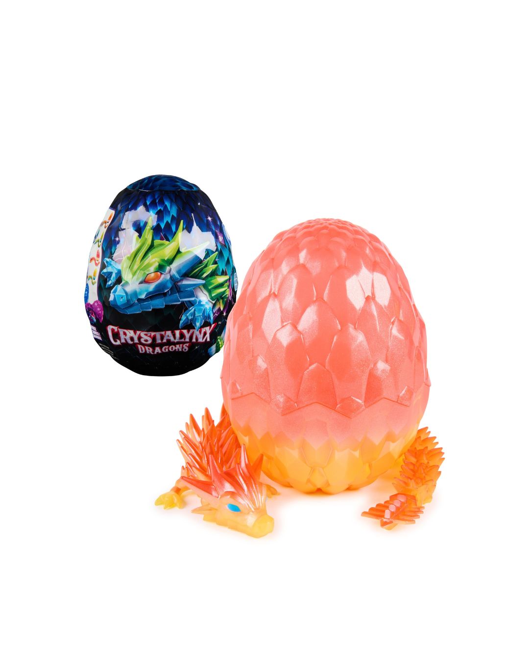 A CrystaLynx toy dragon egg set on a white background, featuring a translucent pink and orange textured egg, a small orange dragon figurine, and a dark blue foil-wrapped CrystaLynx Dragon egg in the background.