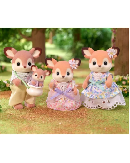 Three sylvanian deer stand on a grassy surface in a garden setting. The left figure holds a small white pot, the center figure wears a pink and lavender dress, and the right figure wears a blue and lavender floral dress.