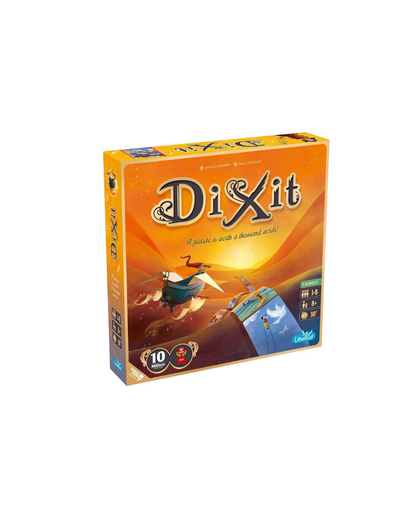 The board game box for 'Dixit' is shown at a three-quarter angle on a plain white background. The box features a bright orange and yellow gradient cover with cartoonish illustrations of characters flying a plane and a landscape, along with the game title 'Dixit' in stylized lettering.