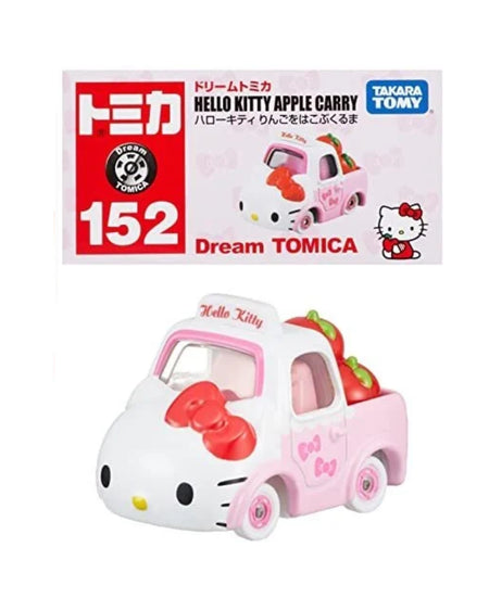Tomica Dream Tomica Hello Kitty Apple Carry toy truck No. (152), shown below its original packaging box on a white background. The toy truck is white and pink with a large red Hello Kitty bow on the hood and strawberries in the back bed.