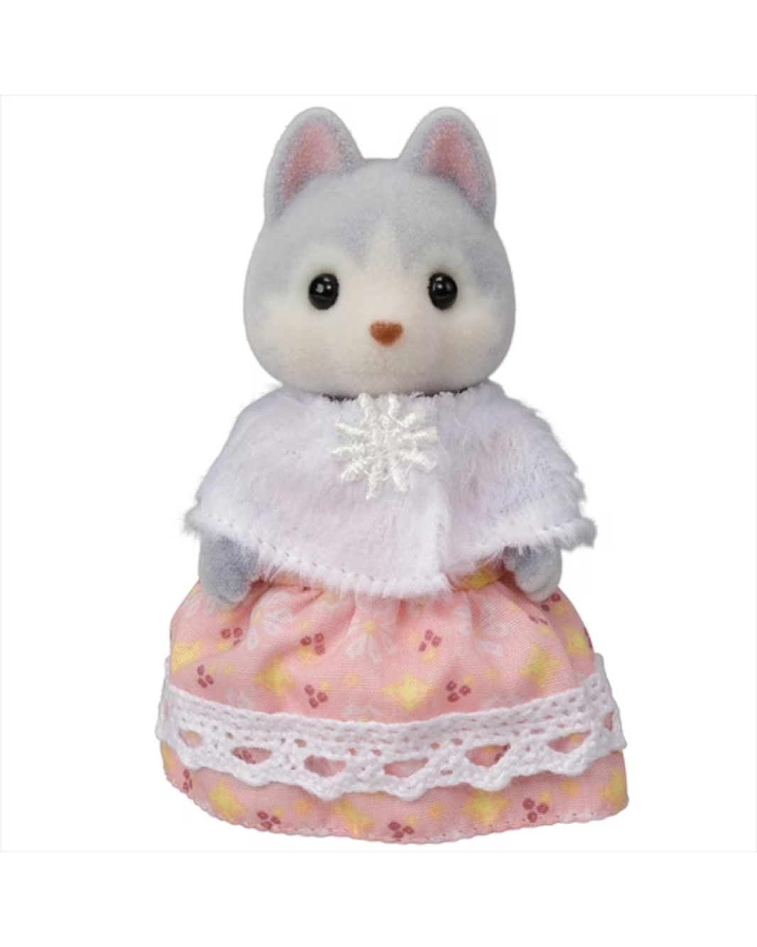 A sylvanian Husky figurine wearing a white fluffy cape with a white snowflake ornament and a pink patterned skirt with white lace trim, isolated on a white background.