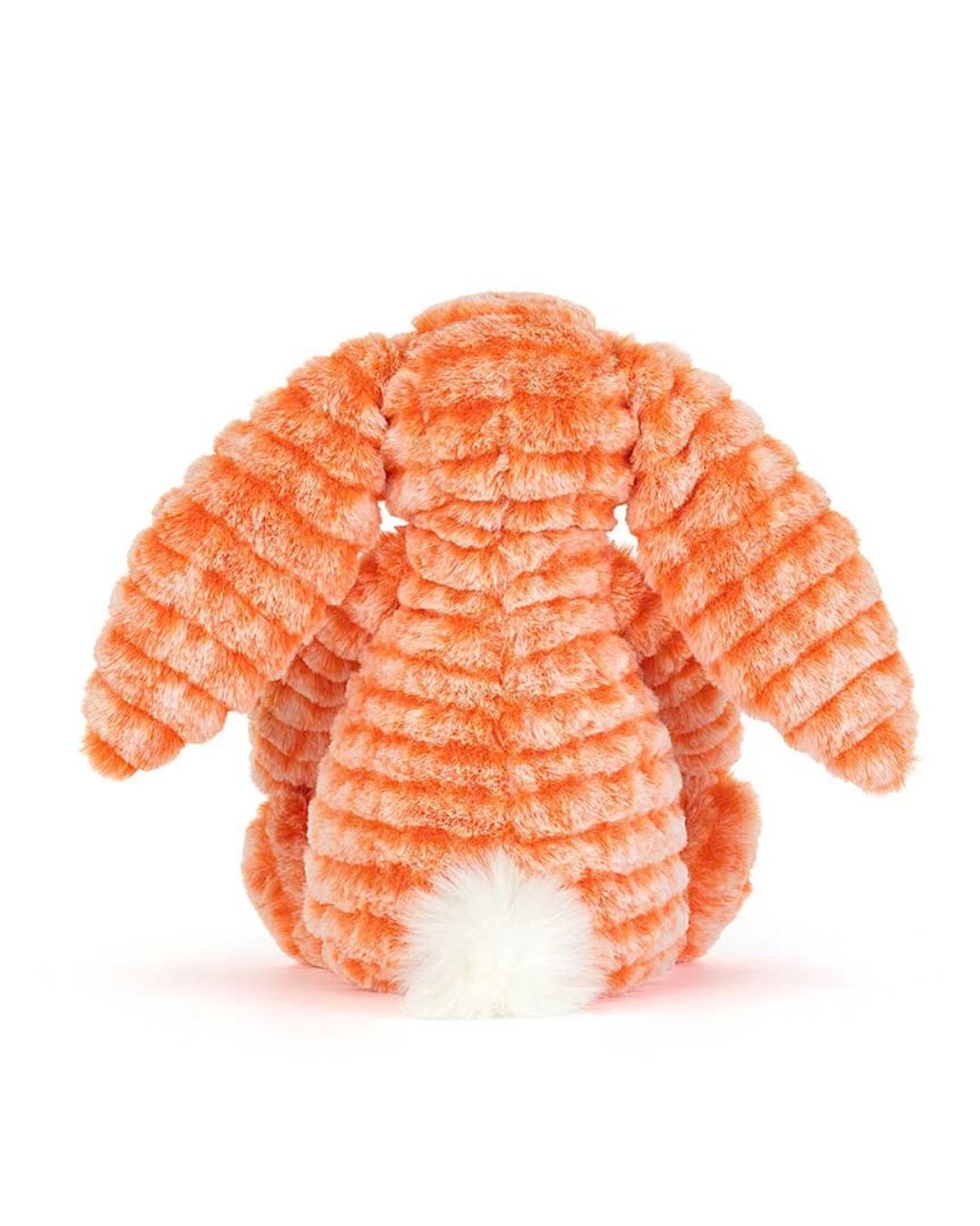 An orange Jellycat Fizzleskip bunny toy with a white fluffy tail, photographed from the back against a clean white background.
