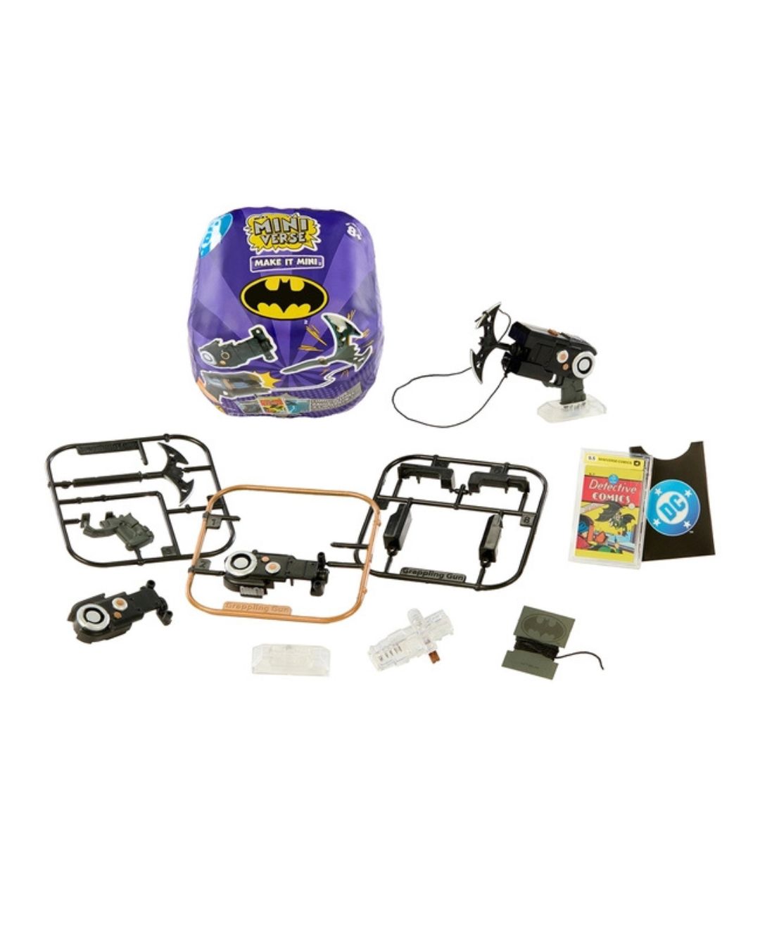 A miniverse toy kit for children, featuring a purple Batman-themed miniverse capsule, various small plastic parts, two black motorized drone-like robots, a small instruction booklet, and a small accessory, all arranged on a plain white background.