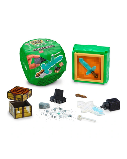 Minecraft-themed toy set with a green round capsule package, a green display box showing a pixelated sword, and several small accessory pieces including a chest, blocks, and small pieces scattered on a white background.