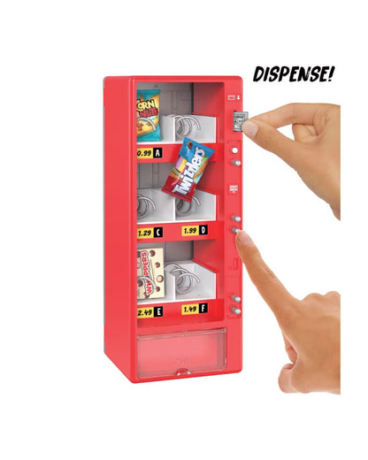 A red toy vending machine with snack compartments and a clear front panel, shown on a white background with two hands pressing buttons and the word 'DISPENSE!' printed in the top right.