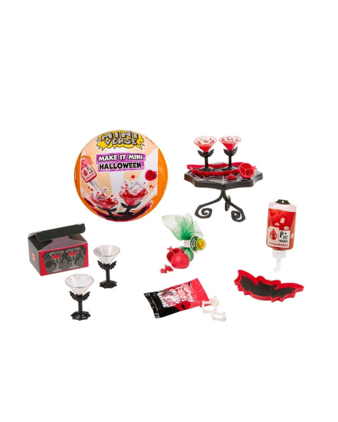 A Halloween-themed mini craft/set displayed on a white background, including a round package labeled 'Make It/Mini Halloween!', a small black stand with red cups, a red-and-black box, two small glasses, a candy, a red apple-shaped item, a tube/container, and a red bat-shaped piece.
