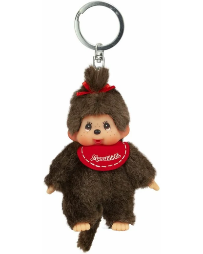 A Monchhichi keychain featuring a small brown plush monkey with a red bow and red bib, attached to a silver metal key ring, shown against a plain white background.