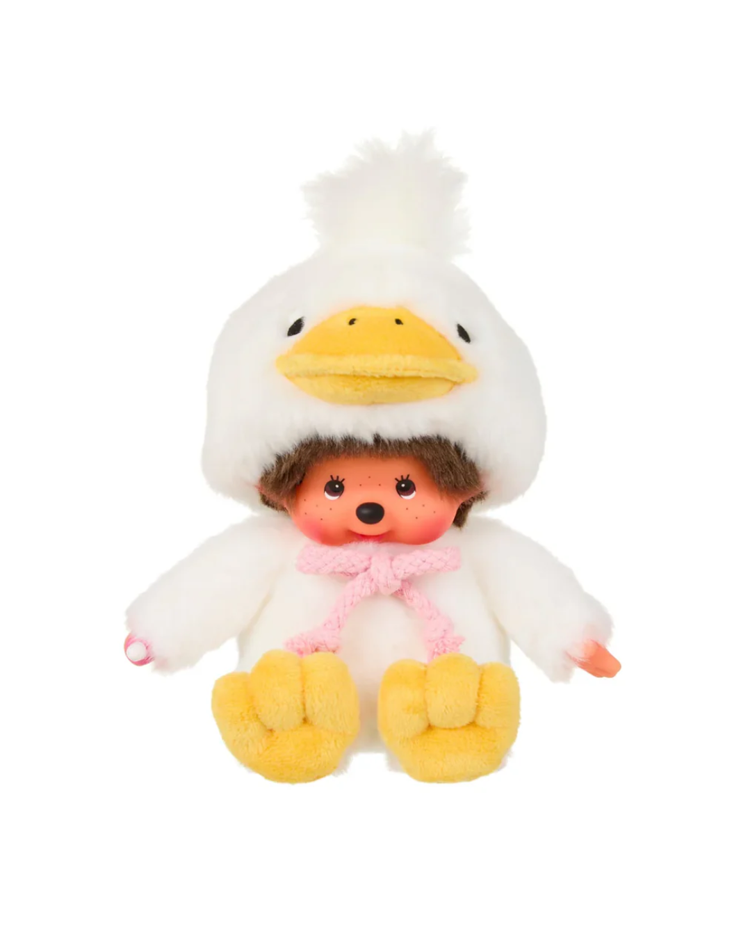 A Monchhichi plush doll with brown hair wearing a white duck costume hood with a yellow beak, pink bow, and yellow feet, isolated on a white background.