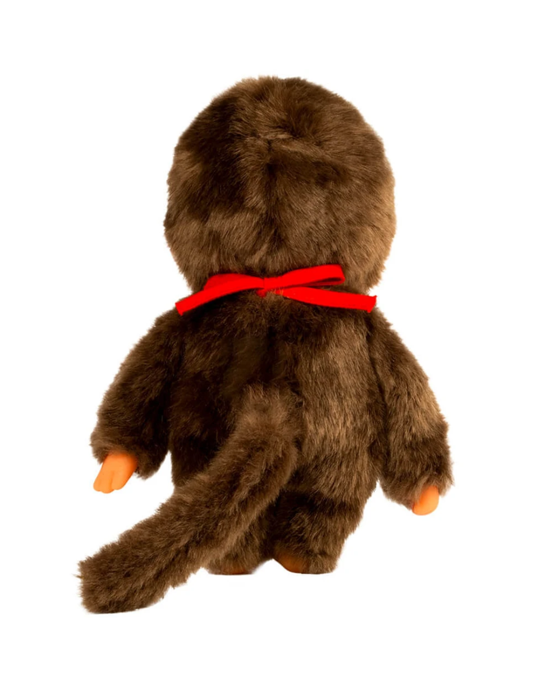 A monchhichi plush monkey toy shown from the back, featuring shaggy brown fur, a bright red bow around its neck, and small orange feet and hands, isolated on a white background.
