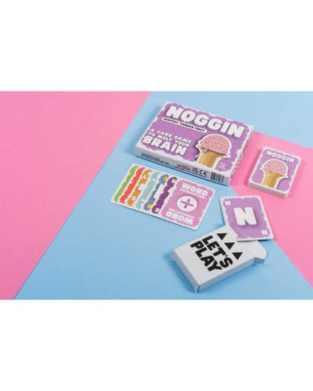 Noggin brand playing cards and card boxes arranged on a pink and light blue background. The set includes a main card box, smaller card packs, and several face-up cards, with one card reading 'GET TO PLAY'.
