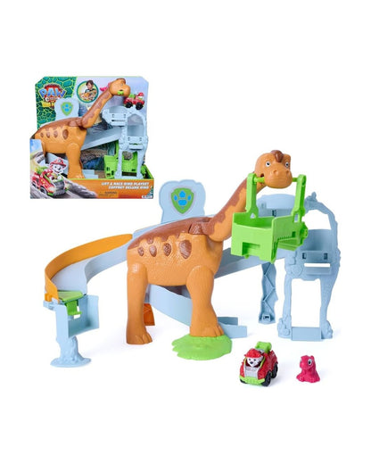 A Paw Patrol toy dinosaur playset featuring a brown and orange Brachycephalus dino figure, a light blue and orange ramp, a green climbing structure, and two small vehicles, shown on a white background with the retail box in the upper left.