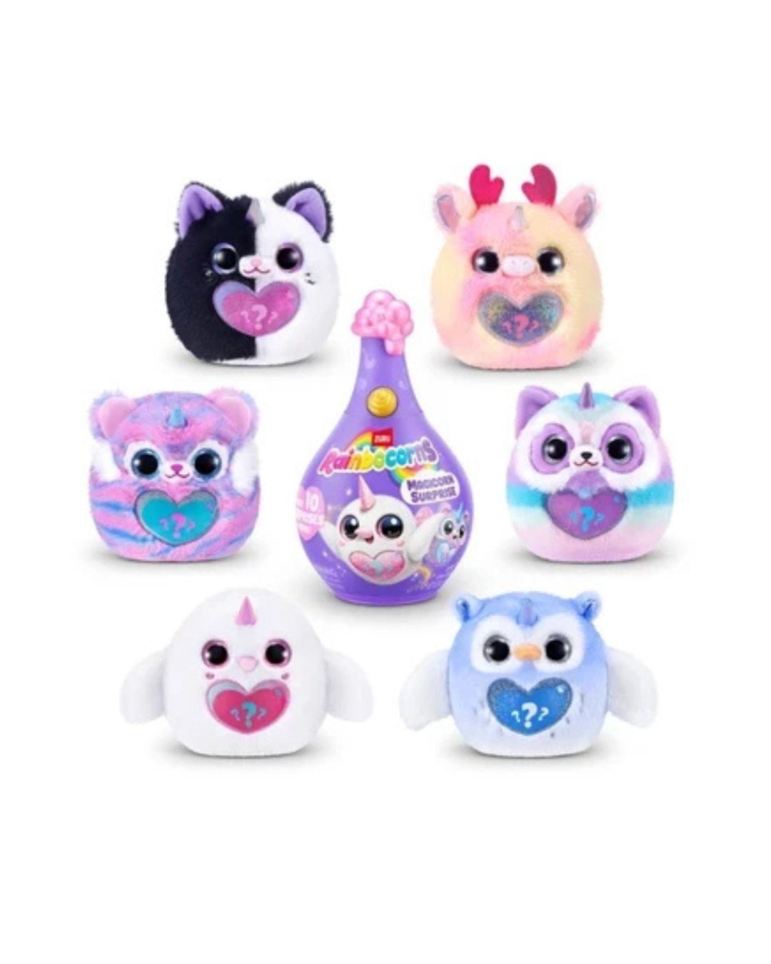 Rainbowcorns Magicorn Surprise Assortment, set of six small plush toys featuring the packaged box they arrive in arranged on a plain white background. The toys include a black-and-white cat, a pink-and-white deer, a pink-and-purple tiger, a blue-and-white raccoon, a white bird with a pink horn, and a light blue owl with a blue heart, plus a purple bottle with colorful graphics.