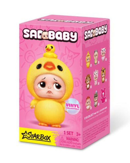 A pink Starbaby vinyl mystery figure box featuring a sad yellow duck-cloaked baby character with a small yellow duck on its head, shown on a white background.