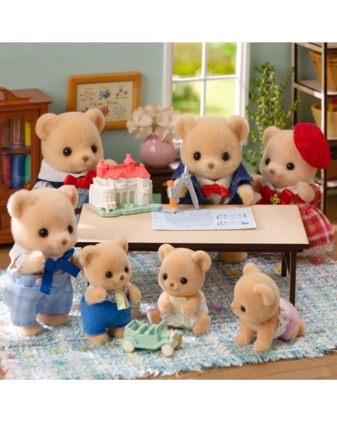 A set of Sylvanian Families toy animal children figures arranged around a small table in a miniature room scene. The figures include several teddy bear characters in different outfits, with one wearing a red beret, one in blue overalls, and others in blue, red, and white clothing.