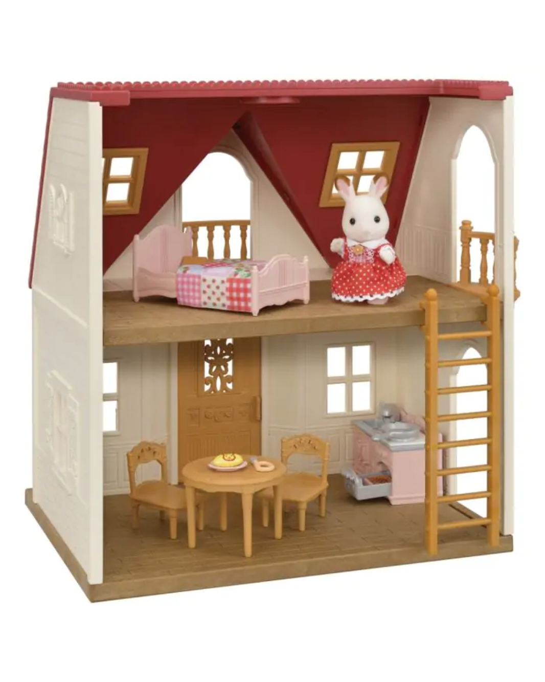 A Sylvanian house playset featuring a two-story cottage with a red roof, cream walls, wooden floors, a pink bed, dining table, kitchen, and a small rabbit figure in a red dress on the upper level.