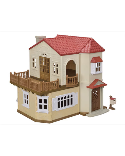 A two storey Sylvanian house featuring a red tiled roof, beige walls, white window frames, a wooden balcony, and a small mailbox figure on a white background.