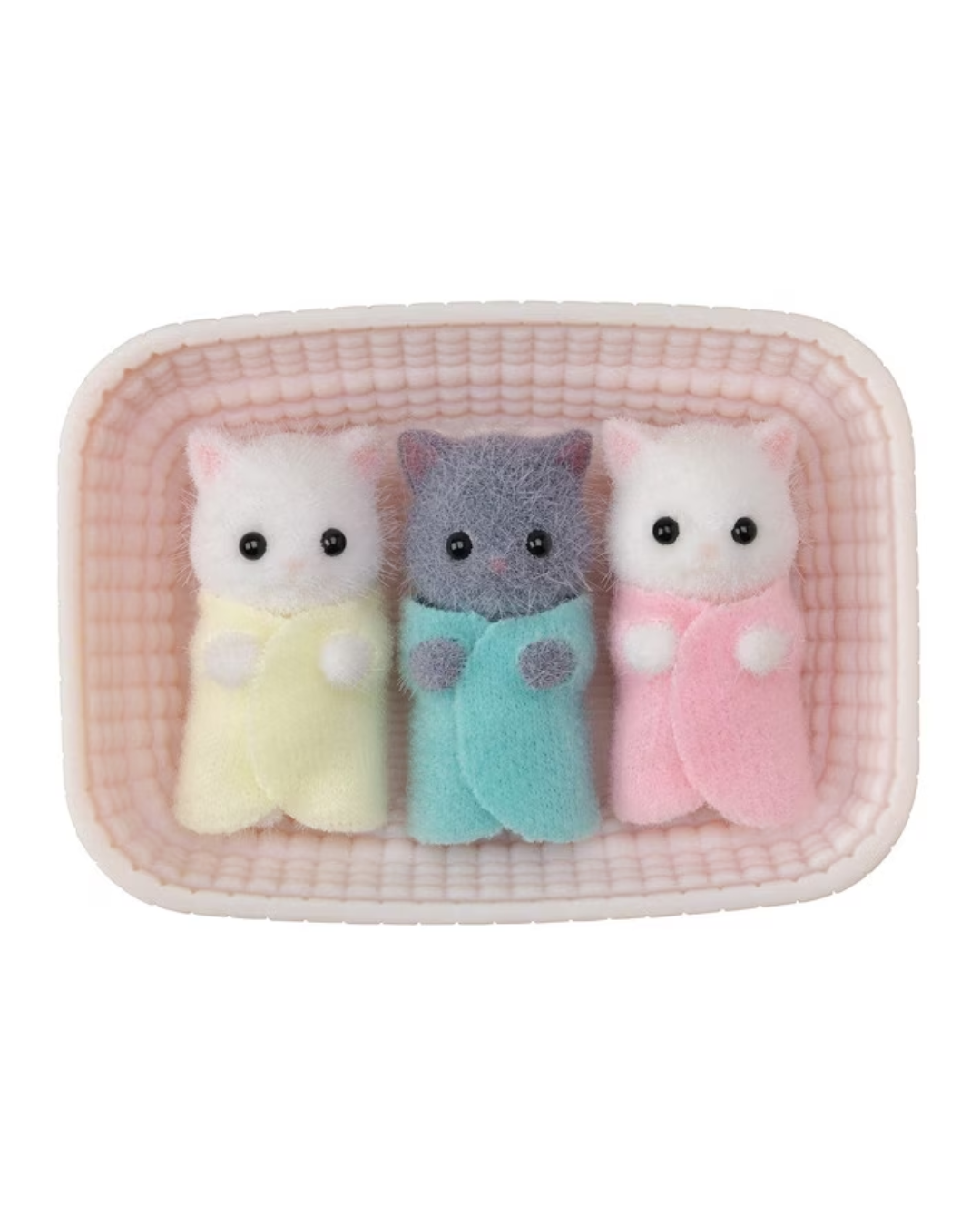 Three small plush cat figurines lying side by side inside a pink textured rectangular tray. The left cat is white with a pale yellow wrap, the middle cat is gray with a light blue wrap, and the right cat is white with a pink wrap.