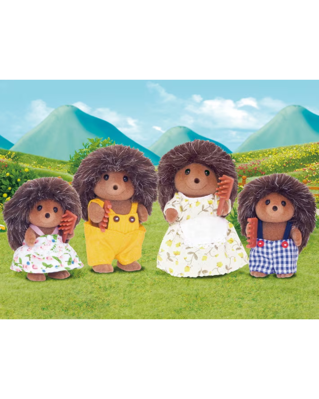 Four hedgehog Sylvanian families figures standing on a green grassy field with blue mountains and a bright sky in the background. The figures wear colorful dresses and shorts in white, yellow, blue, and green floral prints.