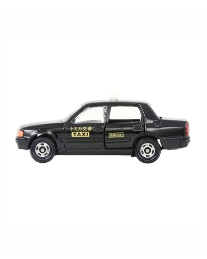 Tomica Tamiya 1:63 scale model car for a No. (51) Toyota Crown Comfort Taxi featuring a black taxi illustration on a white background, with yellow accents and japanese writing. 