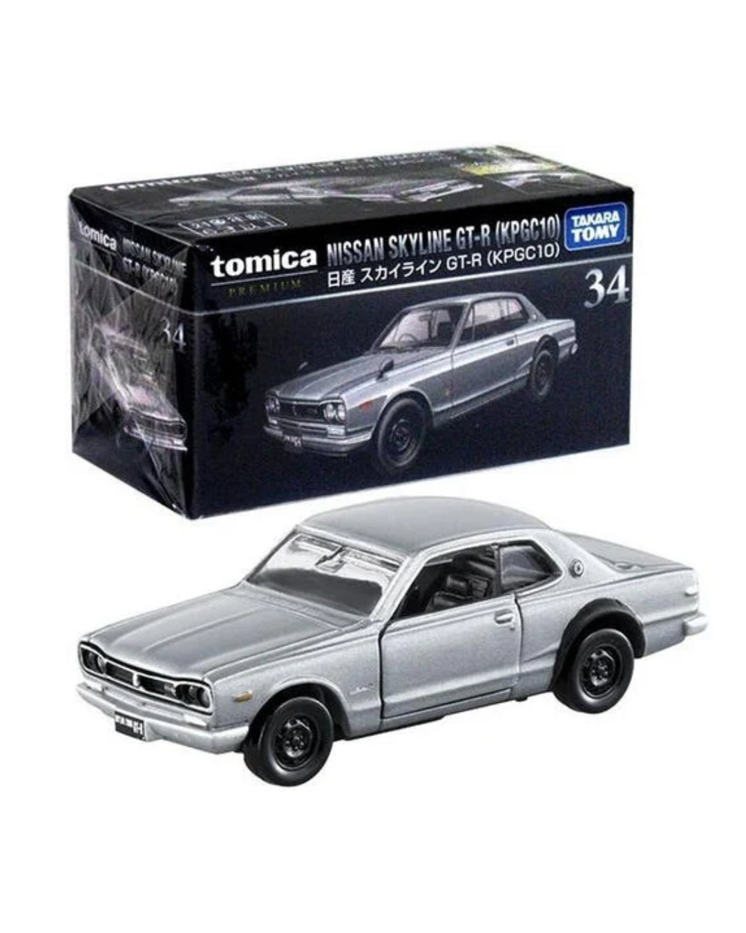 A silver Tomica die-cast model car of a Nissan Skyline GT-R No. (34) (KPGC10) shown in front of its original black packaging box on a white background.