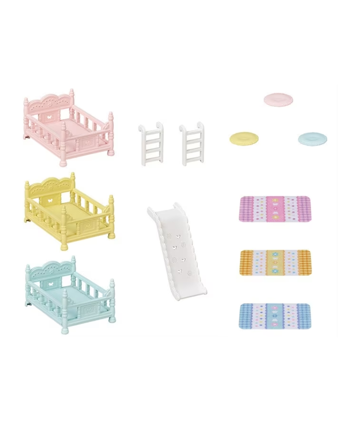 A miniature dollhouse playset featuring three small cribs in pastel pink, yellow, and light blue, a white slide, two white ladders, and several colorful mats and round discs on a plain white background.