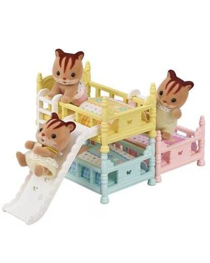 A Sylvanian Families toy set featuring three animal characters playing with a multi-level playhouse. The playhouse has three colorful levels in pastel yellow, mint green, and pink, with a white slide.