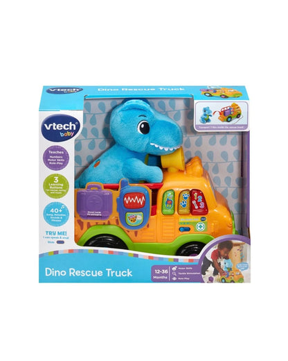VTech Dino Rescue Truck featured in its original retail packaging, with a blue dinosaur plush toy sitting on an orange truck