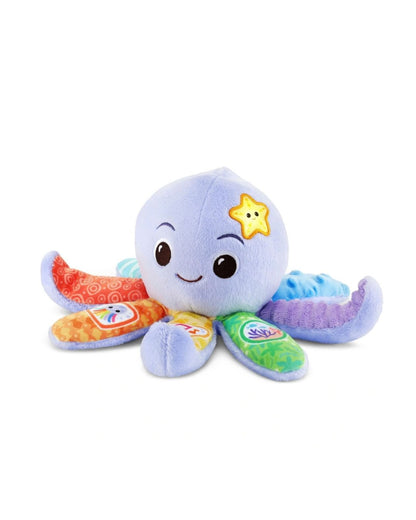 A VTech Baby Snuggles the Octopus plush toy with colorful, patterned fabric tentacles and a yellow star patch on its head, photographed on a solid white background.