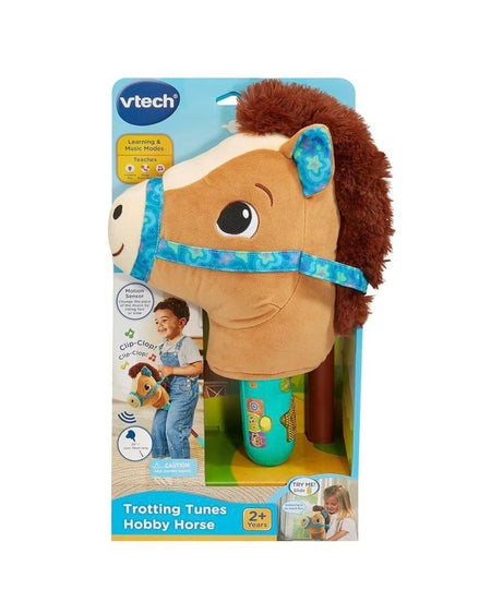 VTech Trottin Tunes Hobby Horse toy in its original retail packaging, featuring a plush brown horse head with a blue patterned bridle and handle, and a turquoise motorized clicker.