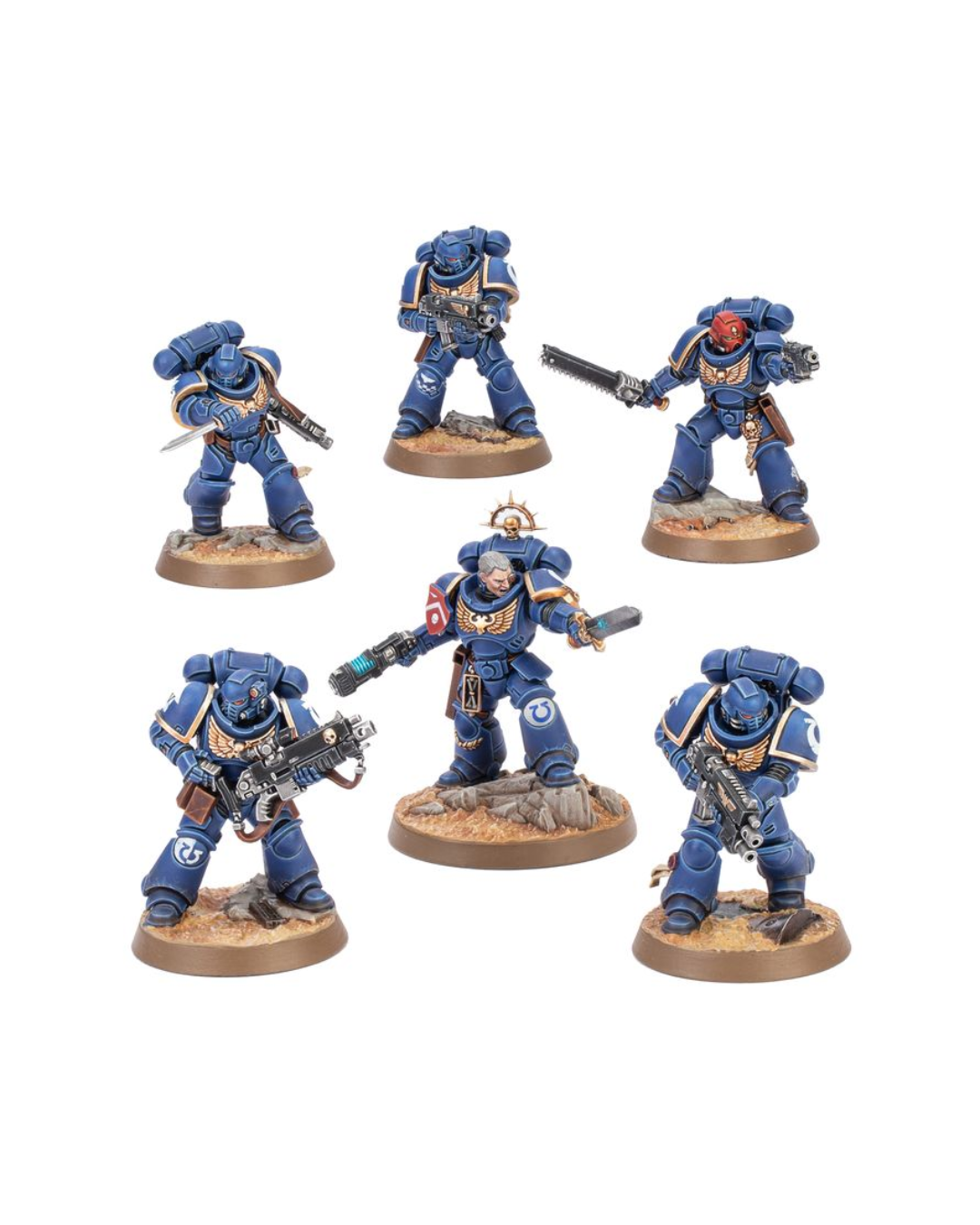 Six painted miniature space marine figures in blue armor with gold trim, posed on round brown bases against a plain white background.