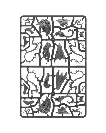 A gray plastic sprue containing multiple unpainted miniature sculpted parts, including dragon heads, claws, wings, and serpentine creatures, isolated on a white background.