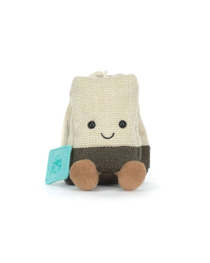 Toy resembling a tea bag with a smiling face on a white background
