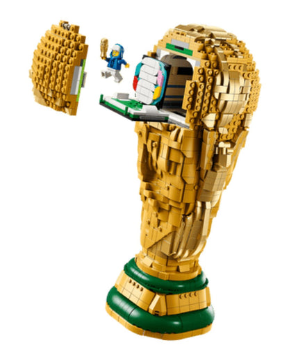 LEGO model of a golden hand holding a trophy on a white background