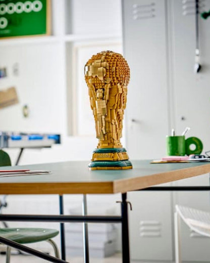Large wooden sculpture on a table with a classroom setting in the background